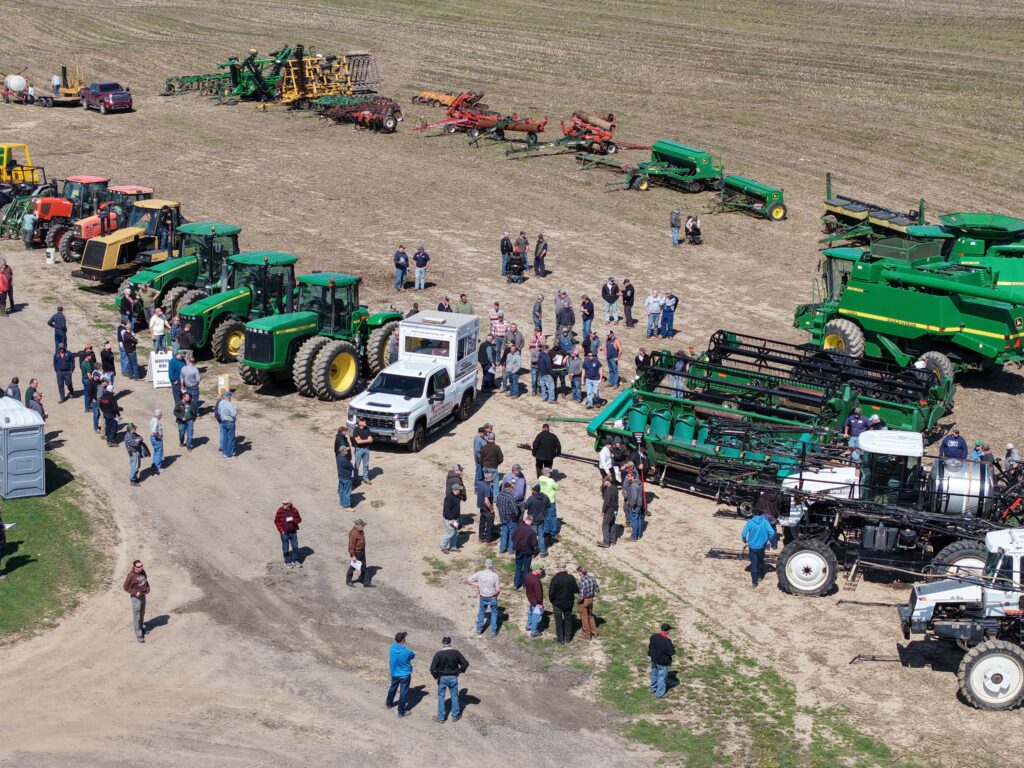 Farm equipment and tractors at a Miedema Auctioneering farm auction in Michigan